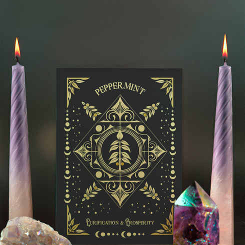 Elegant black card with gold peppermint illustration and celestial symbols. Text reads "Peppermint" and "For Purification & Prosperity" in ornate gold lettering.
